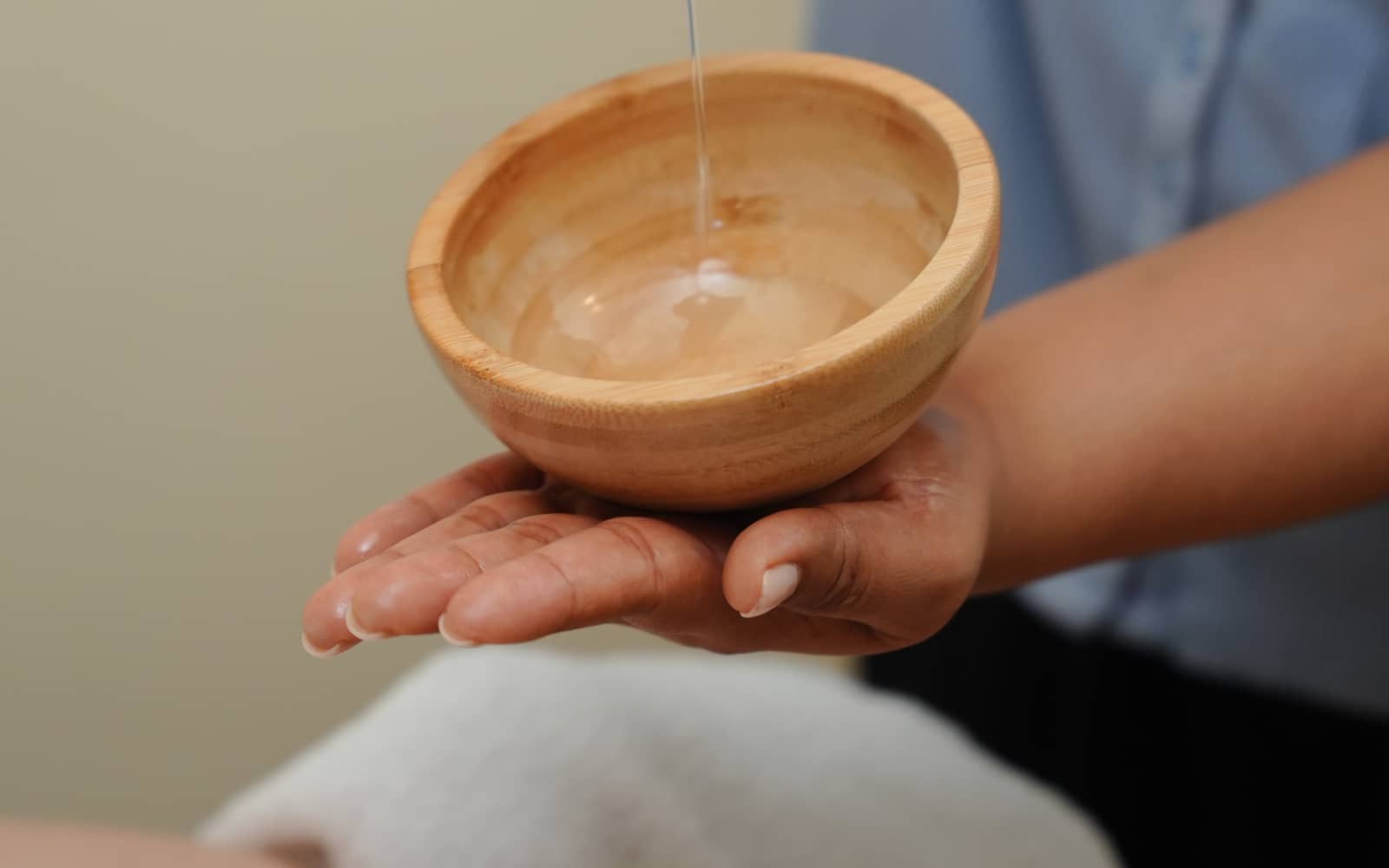 The massage table, prepared with warm towels and oil